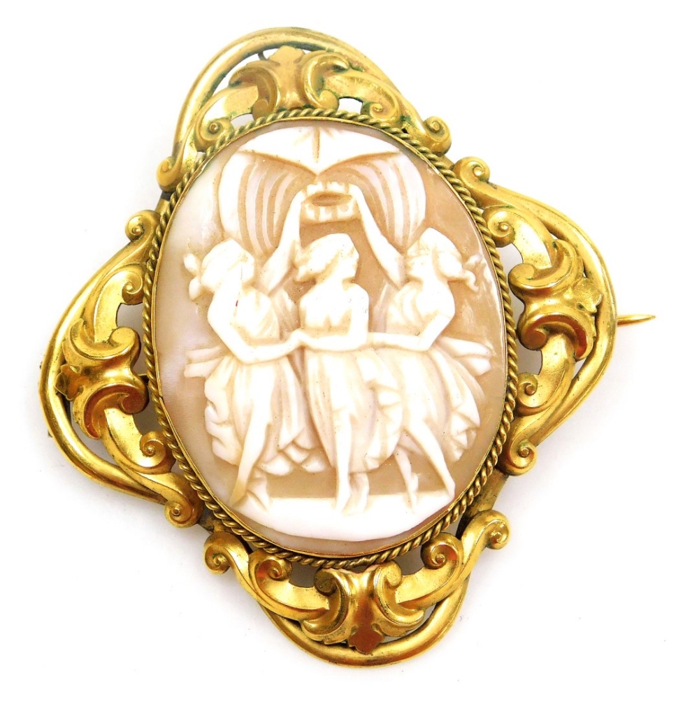 A late 19thC shell cameo brooch, decorated with the Three Graces, in a foiled yellow metal surround,