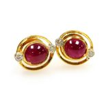 A pair of cabachon ruby and diamond set earrings, the central ruby of 4.8mm diameter, with tiny diam