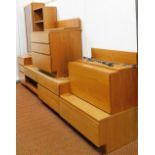A vintage 1960's teak modular lounge unit, comprising a glazed cabinet on a three drawer chest base,