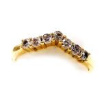 An 18ct gold and seven stone diamond wishbone eternity ring, approx &#8531?ct, size N/O, 3.2g.