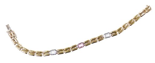 A 9ct bicolour gold bracelet, the three white metal links set with baguette cut topazes, on a snap c