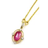 A cabachon ruby set pendant on chain, with diamond accents to the cardinal points with a tiny diamon