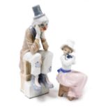 A Lladro porcelain figure of a Pierrot, modelled seated with his head in his hands, together with a