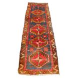 A Kilim blue ground runner, decorated with five central medallions and floral motifs within a repeat