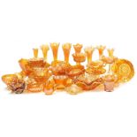 A large group of carnival amber glassware, including vases, bowls, sweetmeat dishes, and sundries. (