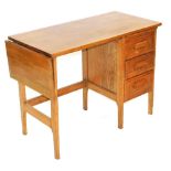 An early 20thC oak desk, with a drop leaf to one end, three drawers to the other, raised on square l