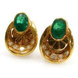 A pair of diamond and emerald stud type earrings, the oval faceted emerald of 4.5mm x 3.2mm with a h