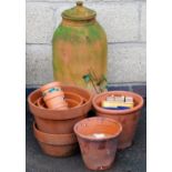 Various terracotta garden pots, and a further planter of bell shaped form, with lid, 72cm high.