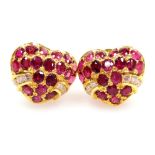 A pair of heart shaped earrings, each set with oval rubies 2.4mm average, and tiny diamond accents t