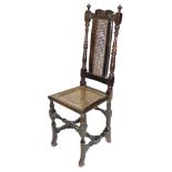 A late 17thC oak and walnut high back chair, with a scroll carved crest rail, cane back, flanked by