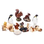 A pair of Poole pottery figures of penguins, together with further glazed and matte figures of anima