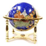 A hard stone terrestrial globe, in a brass gimbal table frame, frame 45cm wide.