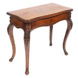 A Victorian mahogany serpentine fold over card table, raised on leaf carved cabriole legs, 79cm high
