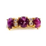 A cabachon ruby and diamond set in line dress ring, three dark rubies of 4.6mm x 3.8mm average, inte