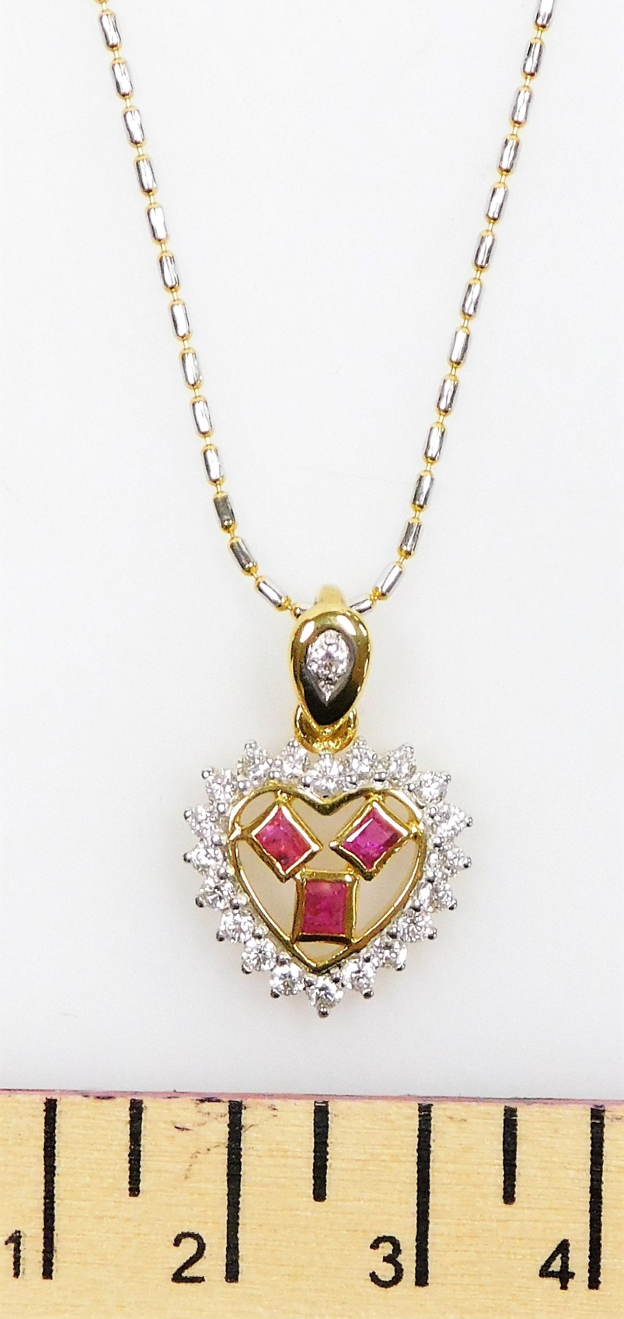 A heart shaped ruby diamond set pendant on chain, three small rectangular rubies surrounded by tiny - Image 2 of 3