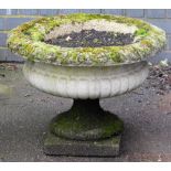 A composition garden planter, of circular part fluted form, on a pedestal base, 44cm high, 66cm diam