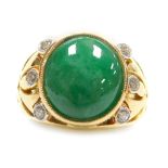 A jade and diamond set dress ring, the cabachon central stone of 12mm x 10.5mm with three small roun