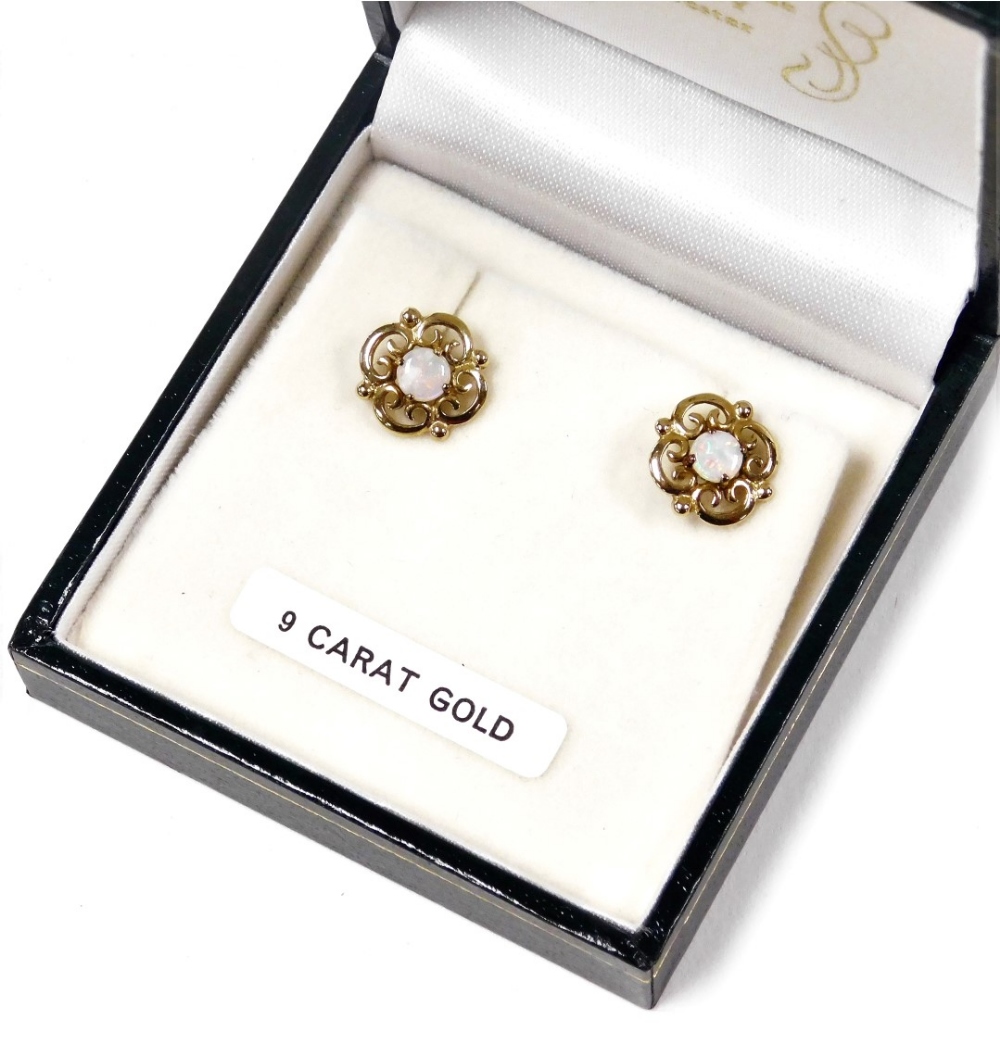 A pair of 9ct gold and opal earrings, in a floral and foliate scroll design, 1.9g.