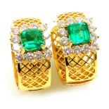A pair of emerald and diamond set hoop earrings, on hinged post backs, each set with a square cut em