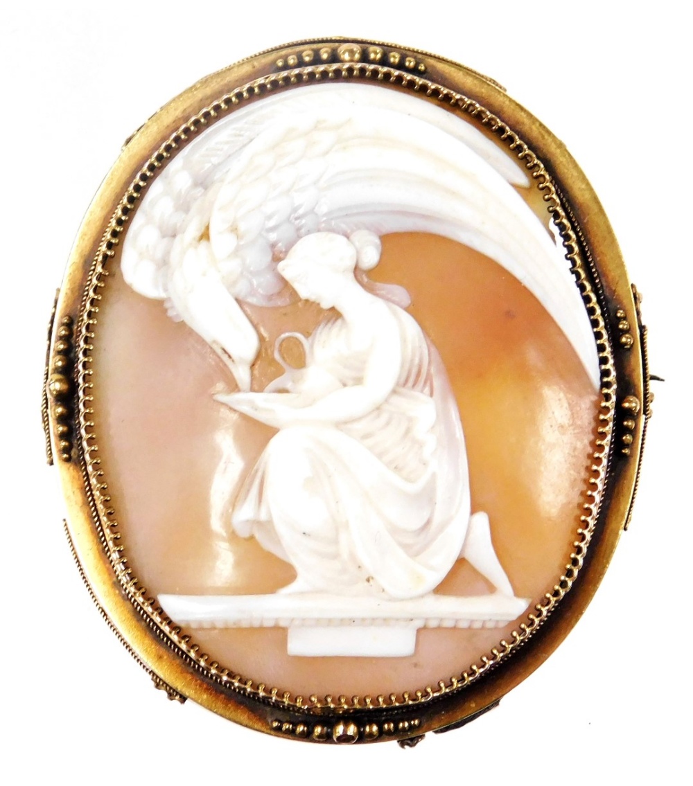 A late 19thC shell cameo brooch, Zeus as an eagle, drinking from a cup held by Hebe, in a yellow met