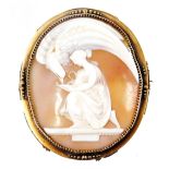 A late 19thC shell cameo brooch, Zeus as an eagle, drinking from a cup held by Hebe, in a yellow met