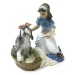 A Lladro Porcelain figure group of a kneeling girl administering medicine to a sick dog in a basket,