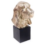 A silver plated bust of a Basset Hound, raised on a square cubed plinth, 34cm high.