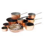 A group of vintage copper saucepans, and frying pans, with brass or cast iron handles. (10)