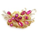 A cabachon ruby and diamond set floral spray brooch, twelve cabachon rubies between 8.2mm and 4.4mm