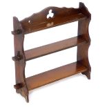 An Arts and Crafts style mahogany set of three open wall shelves, 62cm high, 66cm wide.