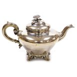 A Victorian silver melon shaped teapot, of plain form, with a floral finial and scroll handle, raise