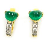 A pair of emerald and diamond set post and clip earrings, the heart shaped cabachon emeralds of 5.2m