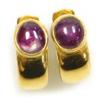 A pair of cabachon ruby clip and post earrings, the rutile included cabachons of 6.3mm diameter appr