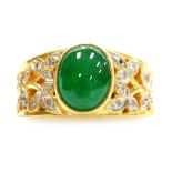 A green cabachon set ornate ring, tiny diamond set shoulders, size J, set in precious yellow metal,