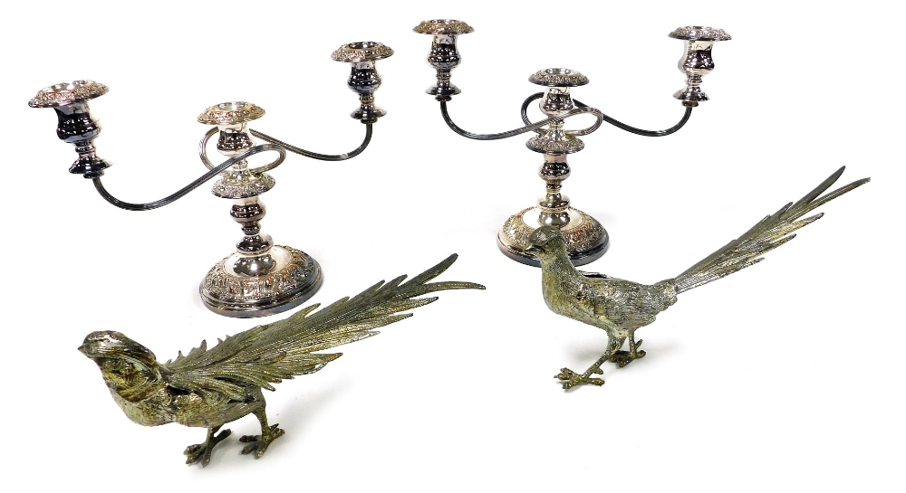 A pair of 20thC silver plated three branch candelabrum, embossed with rococo scrolls, 35cm wide, tog