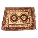 A Turkish Kilim cream ground rug decorated with two central medallions within repeating floral and f