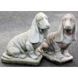 A pair of composition garden figures, of bloodhounds, each 49cm high.