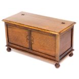 An early 20thC oak blanket chest, raised on ball feet, 49cm high, 91cm wide, 45cm deep,