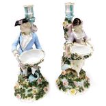A pair of late 19thC Sitzendorf porcelain figural candlesticks, modelled as a gallant and lady, hold
