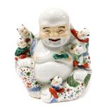 A Chinese porcelain figure of a seated Buddha, with five children, bears oval seal mark, 24cm high.