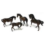 Three Beswick brown gloss horses, together with a foal. (4)