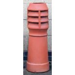 A terracotta chimney pot, 94cm high.