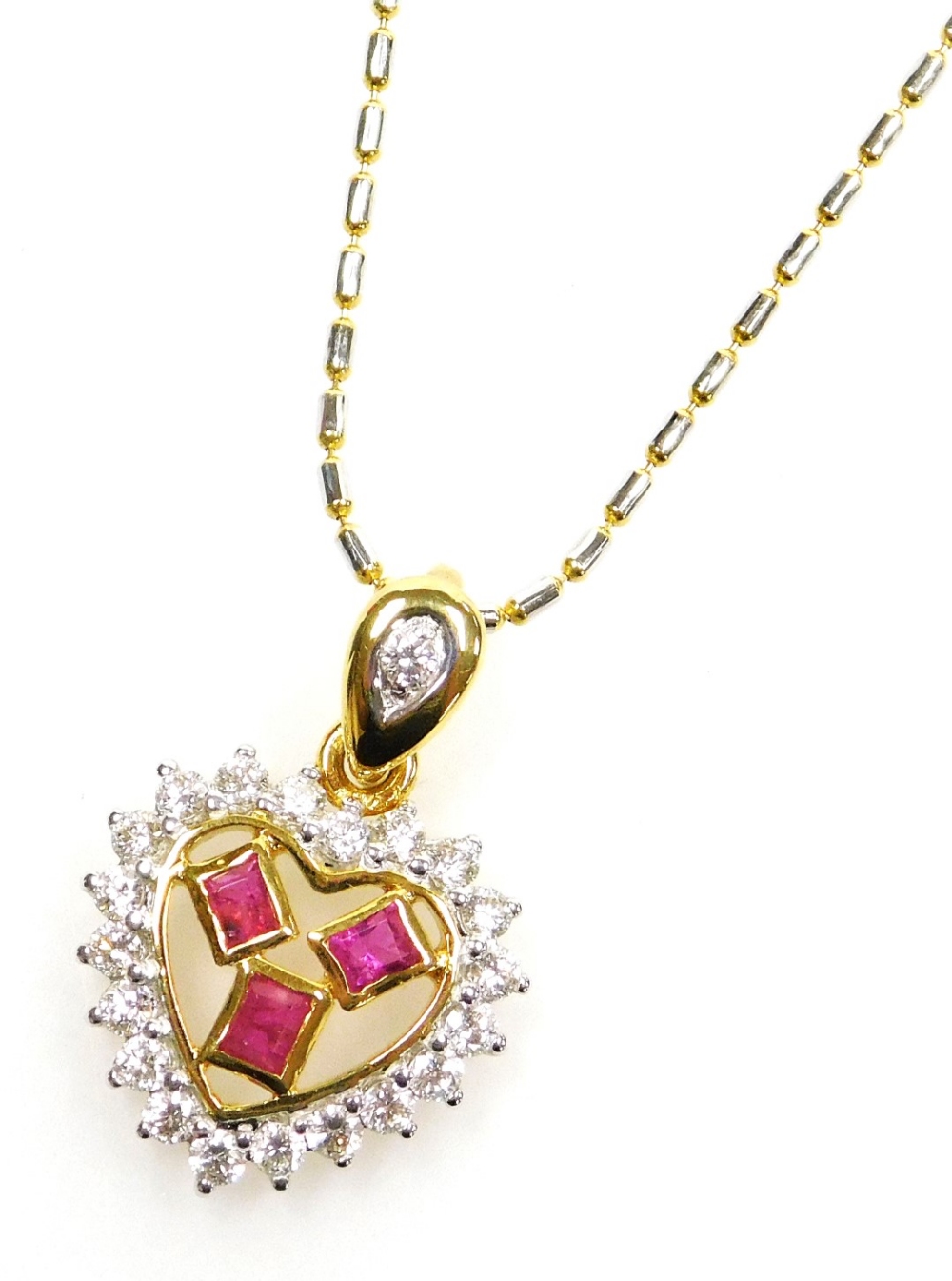 A heart shaped ruby diamond set pendant on chain, three small rectangular rubies surrounded by tiny