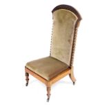 A Victorian rosewood prie dieu chair, the crest rail carved with repeating floral motifs, raised on