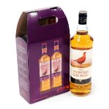Three bottles of Famous Grouse whisky, two in a presentation box.