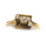 A diamond set dress ring, three small diamonds set diagonally within a square frame, central stone o