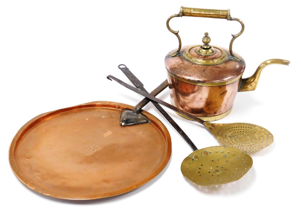 A copper lid with a cast iron handle, stamped VR, a copper and brass kettle, 38cm wide, and brass sk