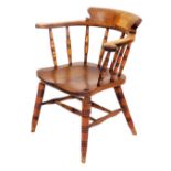 A 19thC oak and elm smoker's bow chair, with a solid saddle seat, raised on turned legs united by a