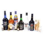 A group of liqueurs and spirits, including sherry, Cinzano, Malibu, Calvados, and assorted miniature