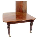 A Victorian mahogany draw leaf dining table, with one and a half additional leaves, raised on turned